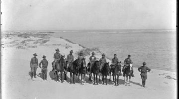 Black and white image of members of the Texas Border Patrol with some on horseback