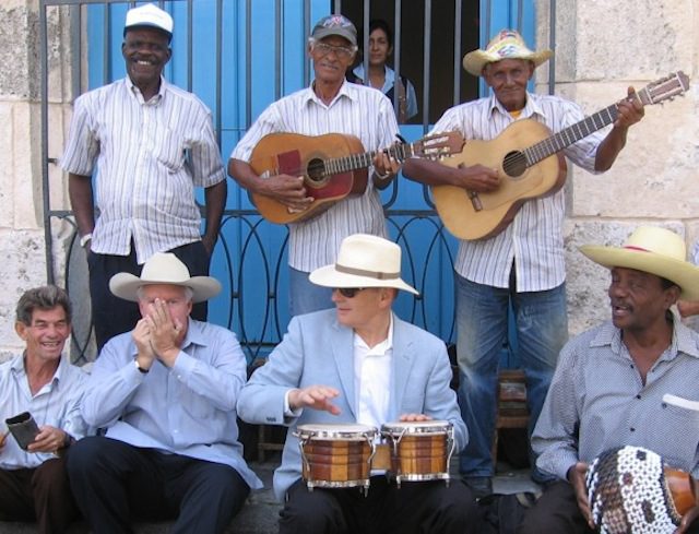 Two visiting yankis sit in with a Havana street band. The author plays the bongos and on my right, John Parke Wright, a Florida cattleman, riffs on the harmonica.