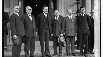 Black and white photograph of Mexican president, Plutarco Elias Calles standing with members of the Apostolic Mexican Catholic Church