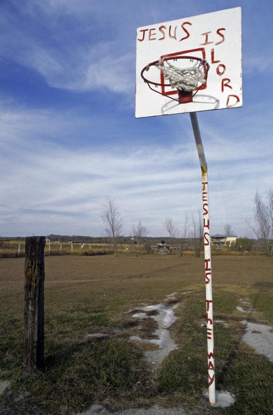 Image of a basketball hoop from a basketball court of a church adjacent to Highway 183 between Austin and Lockhart, Texas
