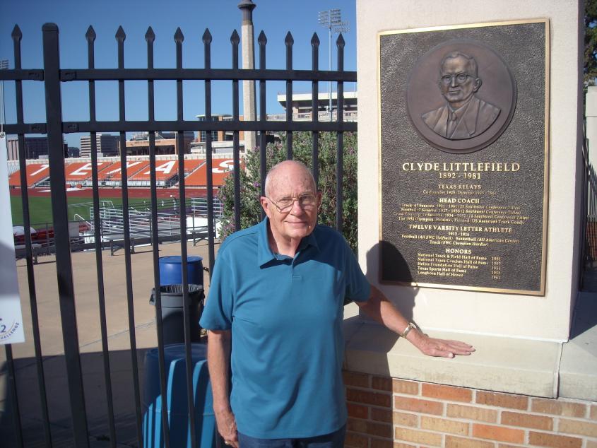 Photograph of Clyde Rabb Littlefield standing next to a plaque memorializing his father