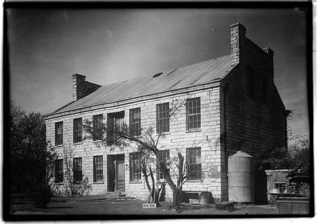 A black and white 1936 photograph of the Sneed House still intact taken by the Historic American Buildings Survey