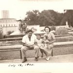 Image of an Asian family from July 19, 1943 sitting on the edge of a fountain on the campus of the University of Texas at Austin