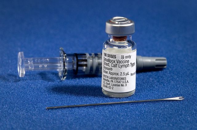 Components of a modern smallpox vaccination kit including the diluent, a vial of Dryvax vaccinia vaccine, and a bifurcated needle (CDC)