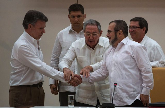 President Raúl Castro of Cuba, center, with President Juan Manuel Santos of Colombia, left, and Rodrigo Londoño, of FARC. Courtesy of Desmond Boylan/Associated Press
