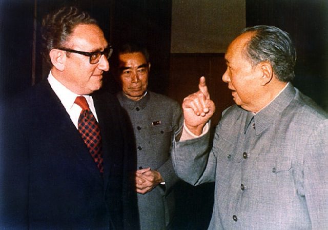 Henry Kissinger and Chairman Mao, with Zhou Enlai behind them in Beijing, early 70s. Via Wikipedia.