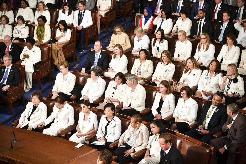 Photograph of women Congress members wearing white attend President Trump’s State of the Union address at the US Capitol on February 5, 2019