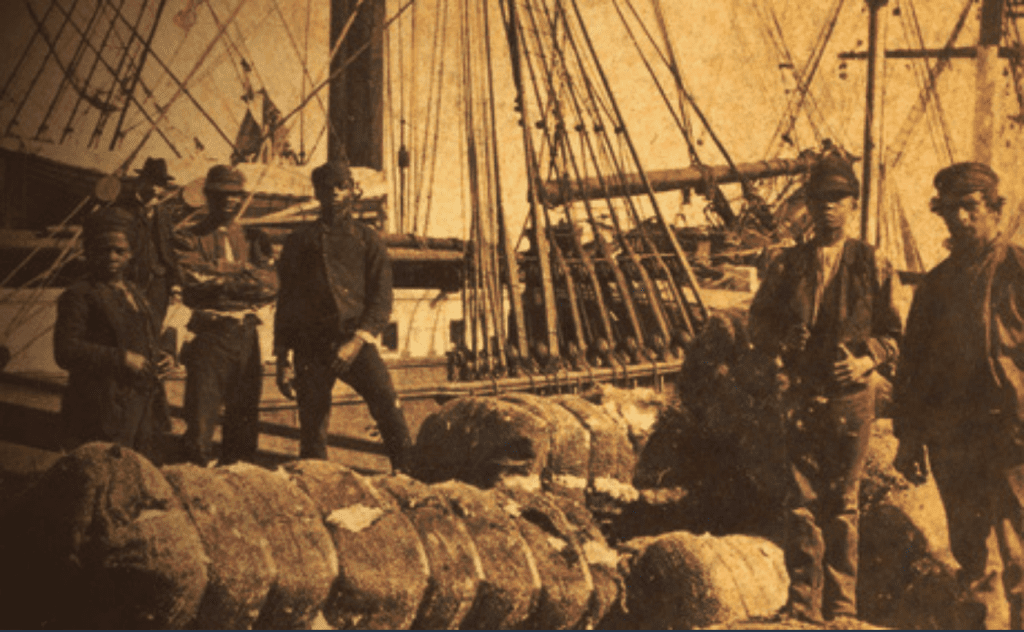 Shipworkers in Savannah, Georgia. On the left, one Black woman and two Black men look toward the photographer with a white man behind them. On the right, a young Black man stands beside a white man.