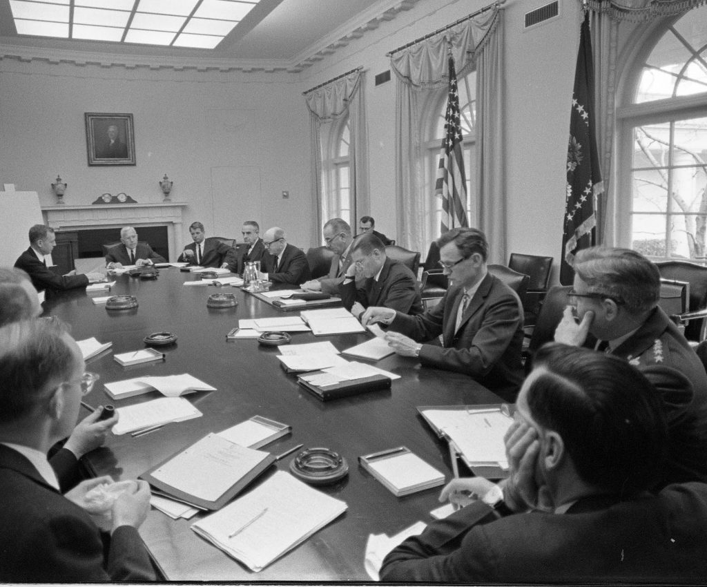 A meeting of the National Security Council on January 7, 1964, reached consensus on the need to keep providing aid to Indonesia despite Sukarno’s provocations. CIA Director John McCone sits at the far end of the table, with Budget Director David Bell to his right and Attorney General Robert F. Kennedy to his left. Around the table in a clockwise direction are Undersecretary of State W. Averell Harriman, Secretary of State Dean Rusk, President Johnson, Defense Secretary Robert S. McNamara, Assistant Secretary of Defense William Bundy, Air Force General Curtis LeMay, an unidentified official, and National Security Adviser McGeorge Bundy.