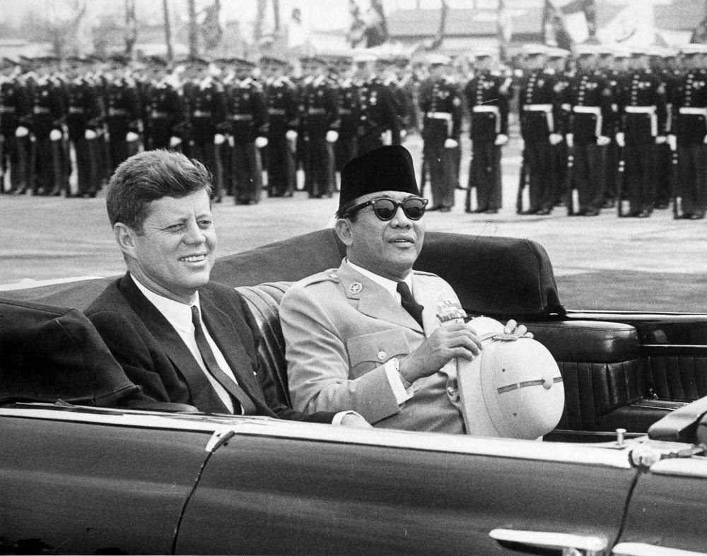 President John F. Kennedy and Indonesian leader Sukarno ride together during arrival ceremonies at Andrews Air Force Base outside Washington, D.C., on April 24, 1961.