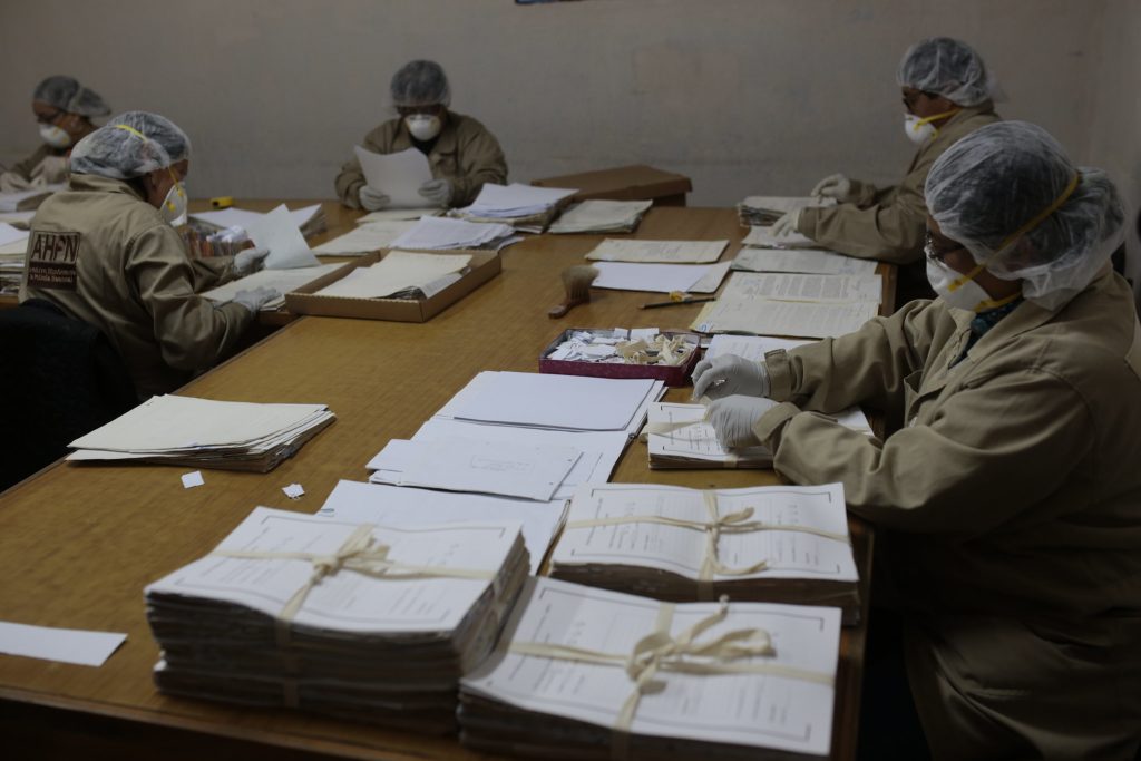 Staff at the National Police Archives process documents