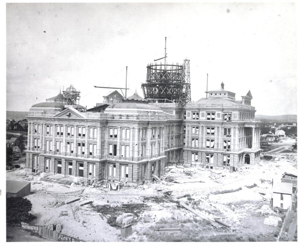 Captured by an unknown photographer, this image of the State Capitol Building under construction was likely taken between 1887 and 1888. The photograph shows the eastern side of the building as well as the scaffolding for the soon to be completed dome.