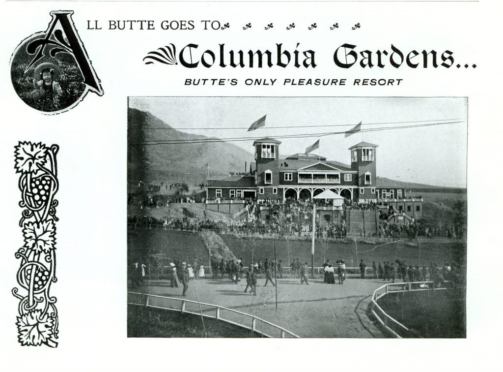 People walk on sidewalks below a large building. Above the photo, the ad reads "All Butte goes to Columbia Gardens... Butte's only pleasure resort."