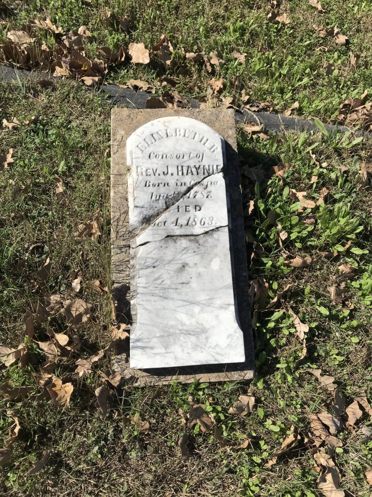 A cracked gravestone bearing the inscription:  "Elizabeth B. Consort of Rev. J. Haynie Born in Georgia, [illegible] 1787. DIED Oct 4, 1863."