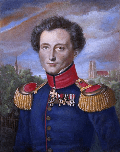 In this nineteenth century portrait by Karl Wilhelm Wach, a smiling Carl von Clausewitz sports a row of medals and a blue military uniform with a high red collar and large epaulettes. Trees and church spires are visible in the background.