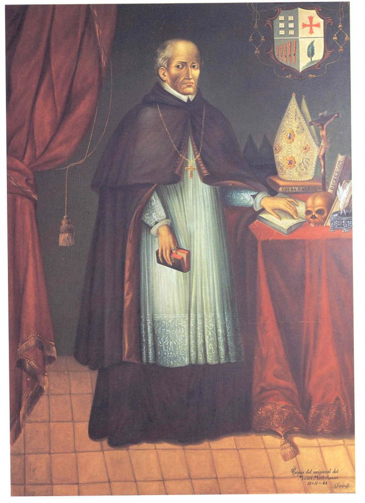 Vasco de Quiroga--a balding, grey-haired, solemn-faced man in clerical robes--rests his left hand on an open book atop a cluttered table in this full-length portrait. A skull, an inkwell with quills, more books, and a clerical hat also stand on the table; Quiroga is holding yet another book in his right hand, using his index finger as a bookmark. A coat of arms is visible in the upper right-hand corner.