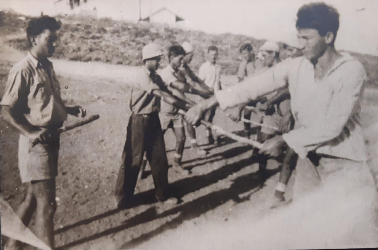 Atar's grandfather, to the right, practicing face-to-face combat. 