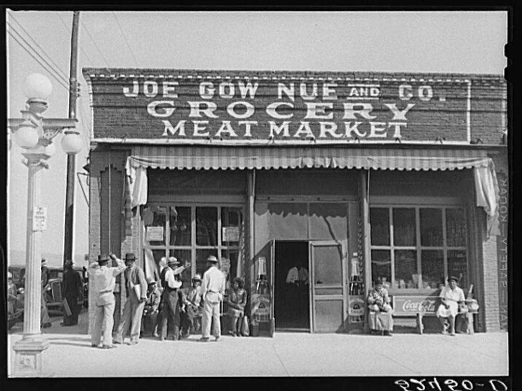 Chinese grocerymen and merchants in fron to a store in the Mississippi Delta