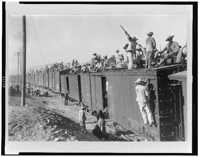 Yaqui Indians, enlisted in the Mexican Army, being transported by box cars.