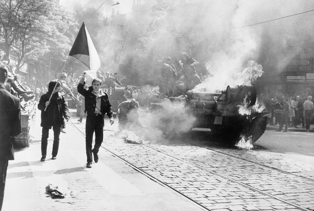 The Soviet Invasion of Czechoslovakia. Tanks burning. People carrying flags