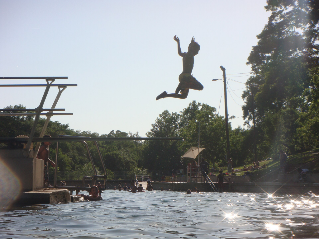 Kid jumping into the water at Barton Springs
