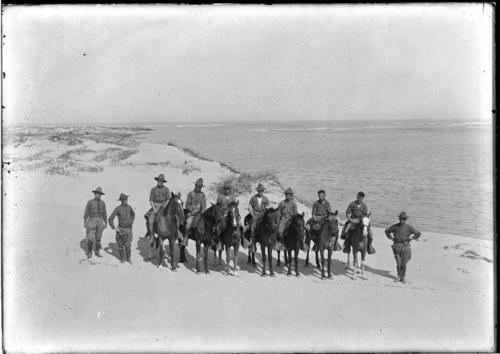 Black and white image of members of the Texas Border Patrol with some on horseback